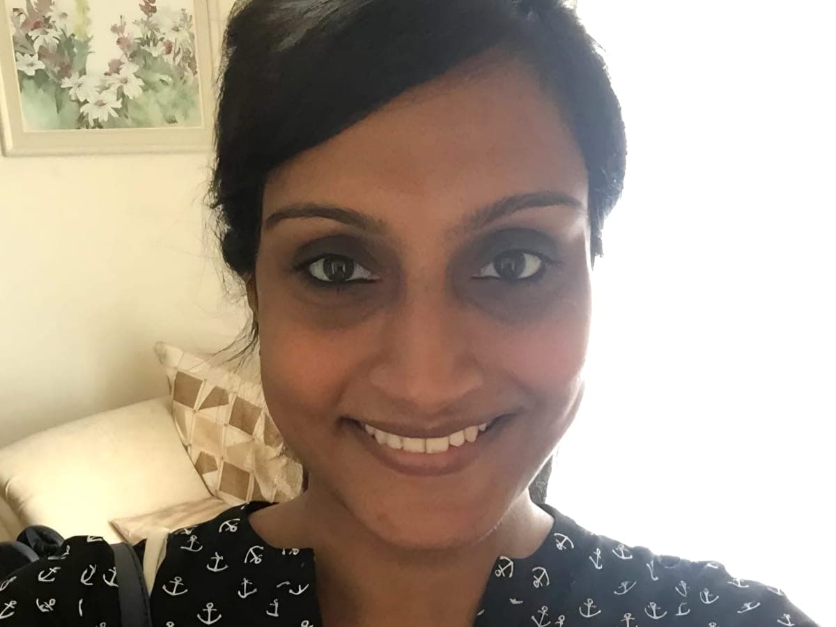 Thivya smiling at home